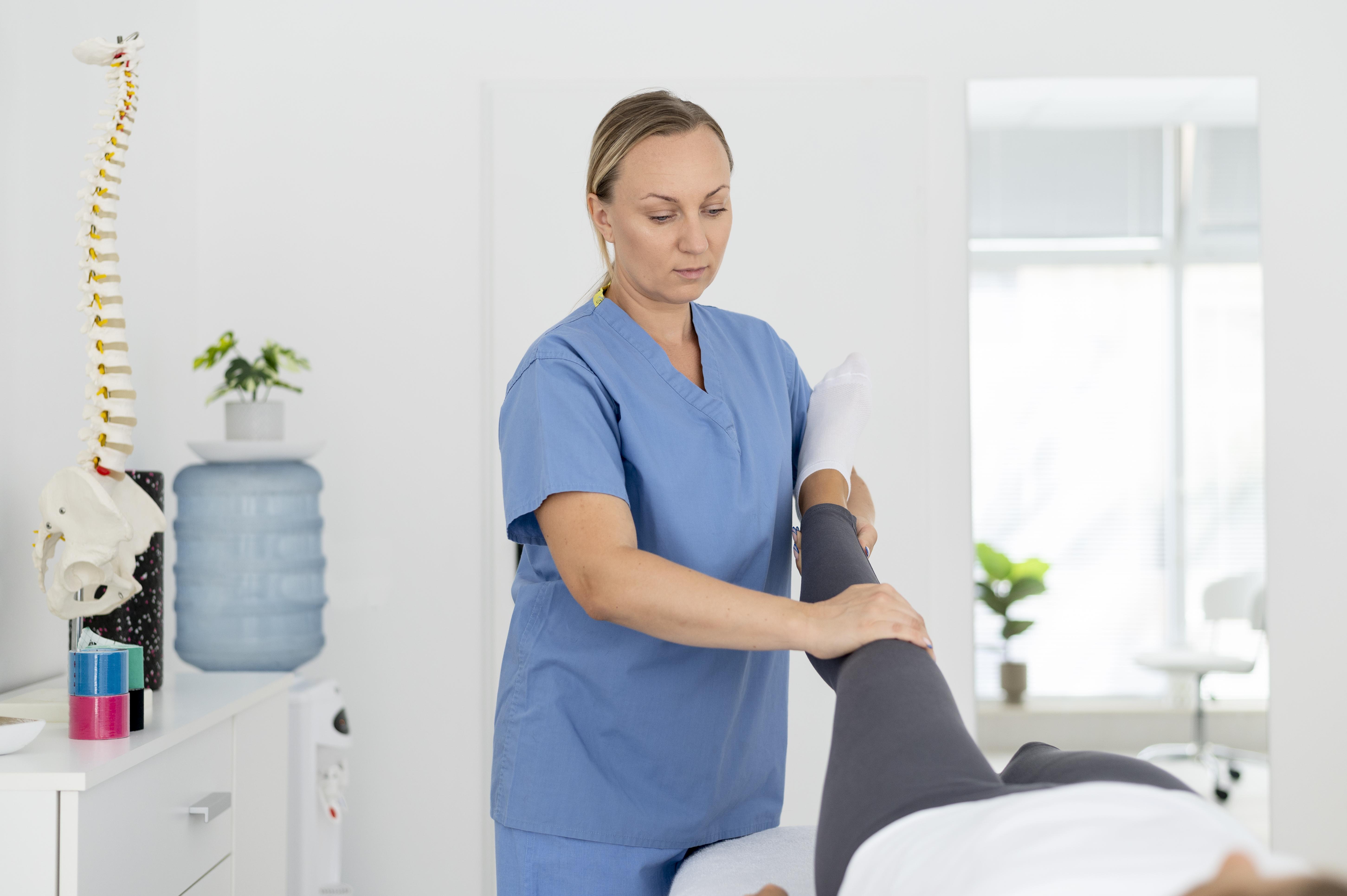 Physiotherapist supporting a patient during a home visit